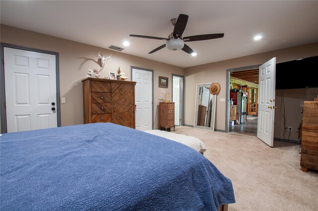 bedroom featuring a ceiling fan, recessed lighting, visible vents, and light carpet