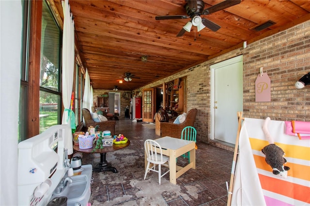 sunroom featuring wooden ceiling and ceiling fan