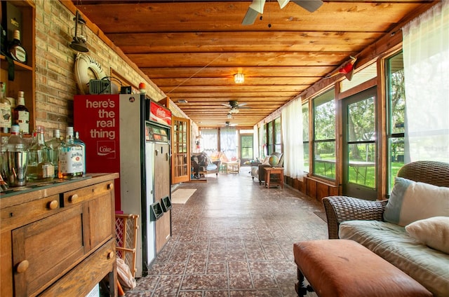 sunroom featuring wooden ceiling and ceiling fan