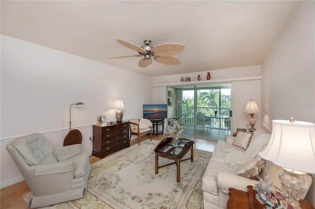 living room with ceiling fan and light wood-type flooring