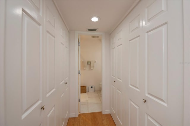 hallway with light hardwood / wood-style floors