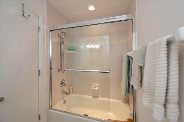 bathroom featuring combined bath / shower with glass door