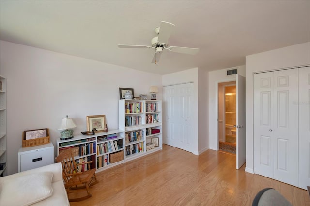 living area featuring ceiling fan and light hardwood / wood-style floors