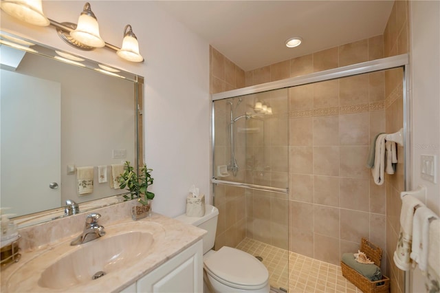 bathroom with toilet, vanity, and walk in shower