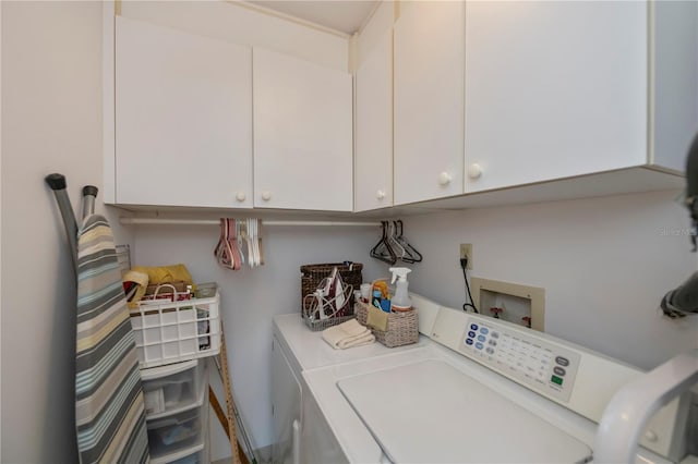 laundry area featuring washing machine and dryer and cabinets