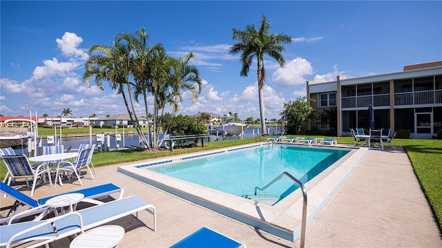 view of swimming pool with a lawn and a patio area