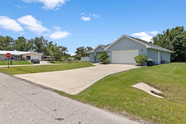 single story home featuring a front lawn, concrete driveway, central AC, and an attached garage