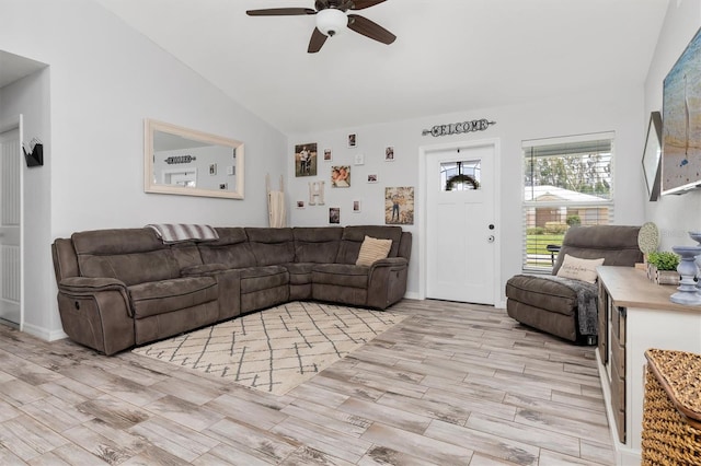 living room featuring ceiling fan, light wood-type flooring, and lofted ceiling