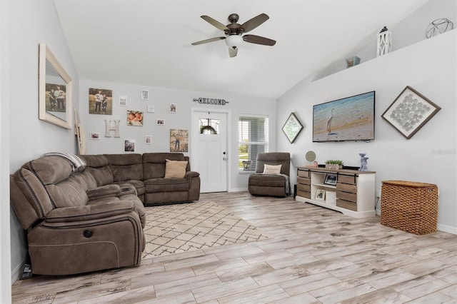 living room with ceiling fan, light hardwood / wood-style flooring, and lofted ceiling