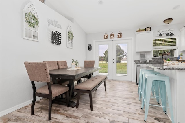 dining room featuring light wood-type flooring and french doors