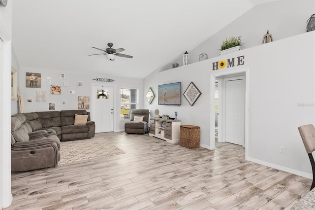 living room featuring ceiling fan, high vaulted ceiling, and light hardwood / wood-style floors