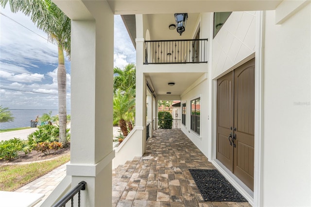 view of patio with a water view and a balcony