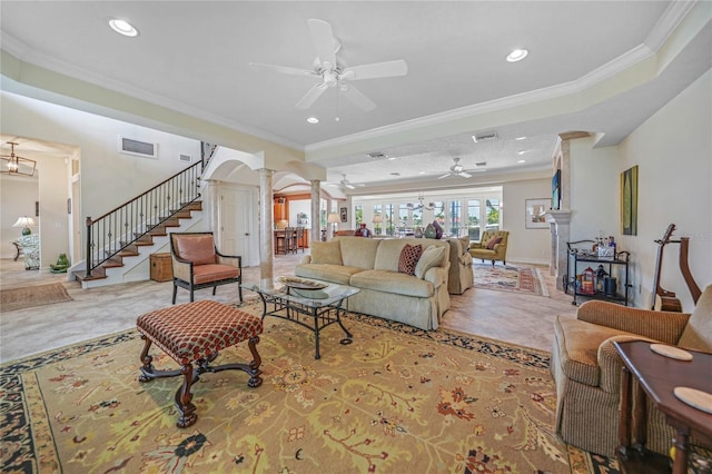 living room featuring ornamental molding, visible vents, ornate columns, and stairs