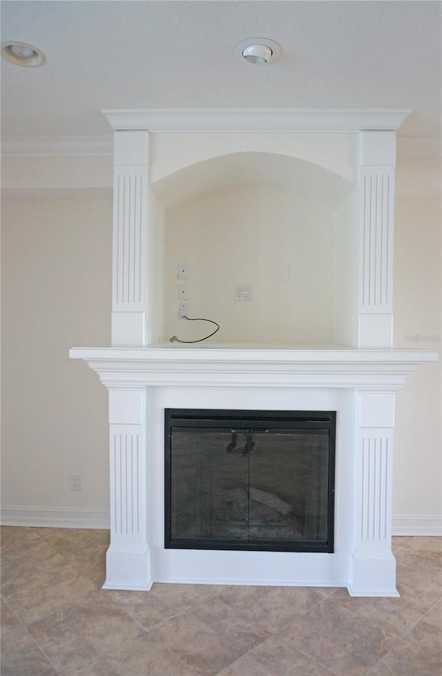 interior details featuring baseboards, a fireplace, and crown molding