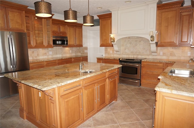 kitchen with appliances with stainless steel finishes, a sink, and light tile patterned floors