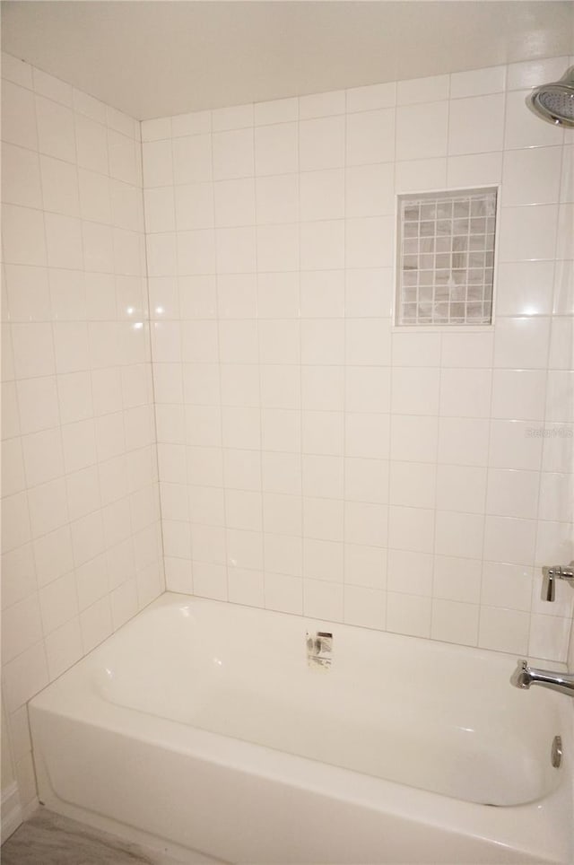 bathroom with visible vents and bathing tub / shower combination