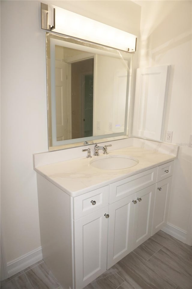 bathroom featuring baseboards and vanity