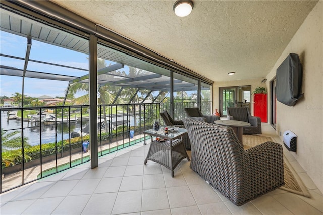 sunroom / solarium with a water view and a healthy amount of sunlight