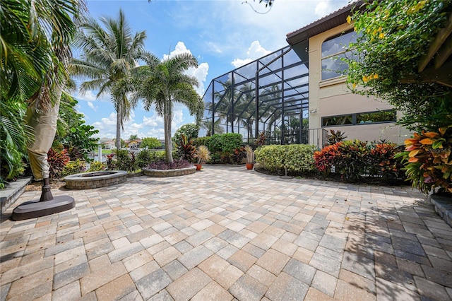 view of patio with a lanai and a fire pit