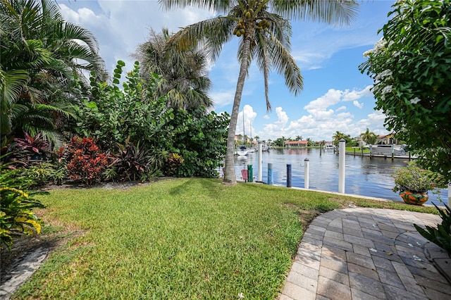 view of yard featuring a dock and a water view