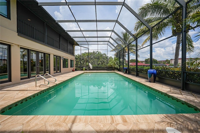 outdoor pool featuring a patio area and a lanai