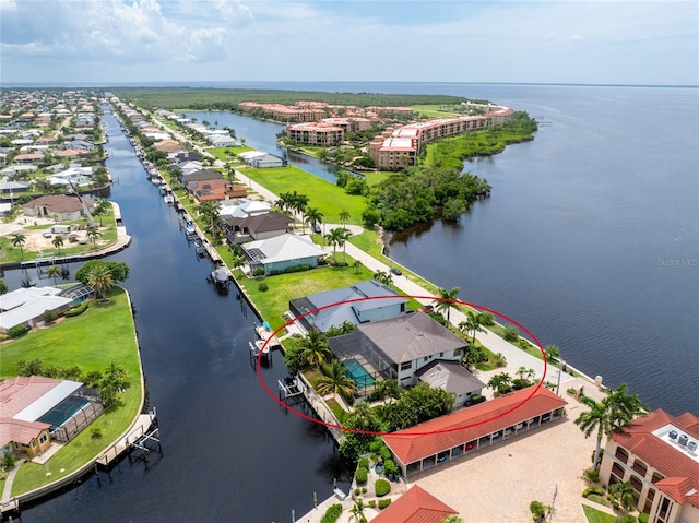 drone / aerial view featuring a water view and a residential view