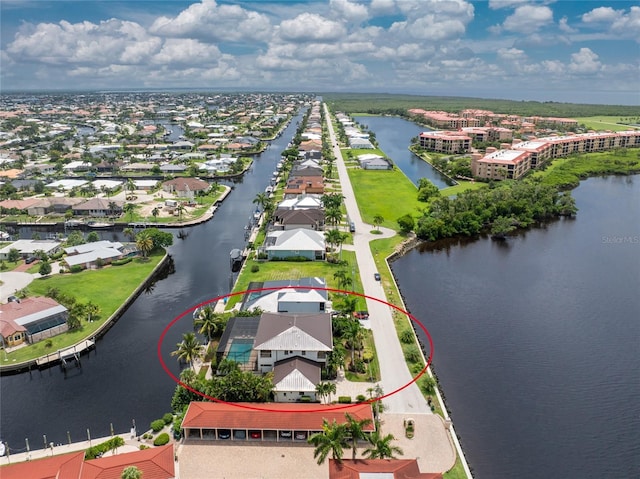 birds eye view of property featuring a water view and a residential view