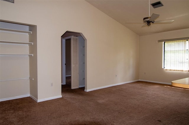 unfurnished bedroom with dark colored carpet, ceiling fan, and vaulted ceiling