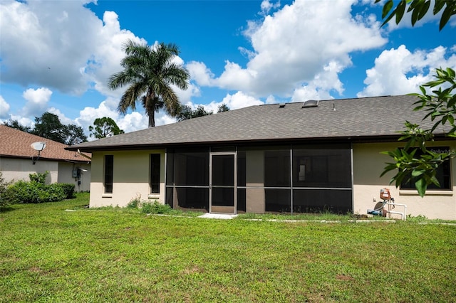 back of house featuring a sunroom and a yard