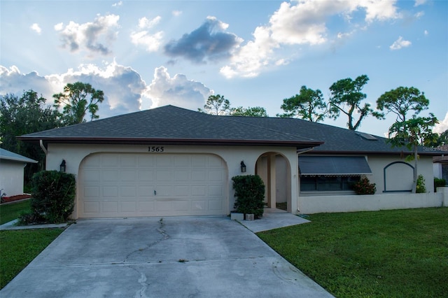 single story home featuring a shingled roof, concrete driveway, an attached garage, a front lawn, and stucco siding