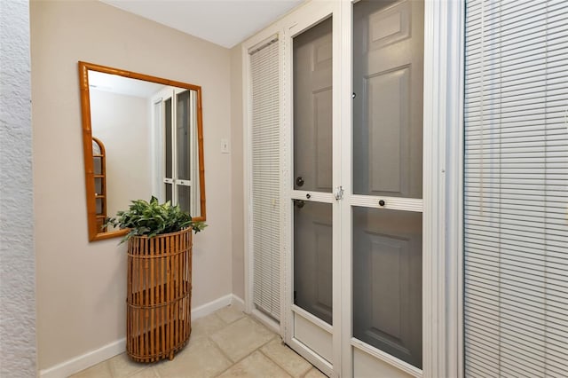 doorway featuring light tile patterned flooring