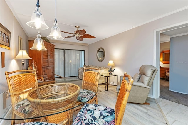 living room with crown molding, ceiling fan, and light wood-type flooring