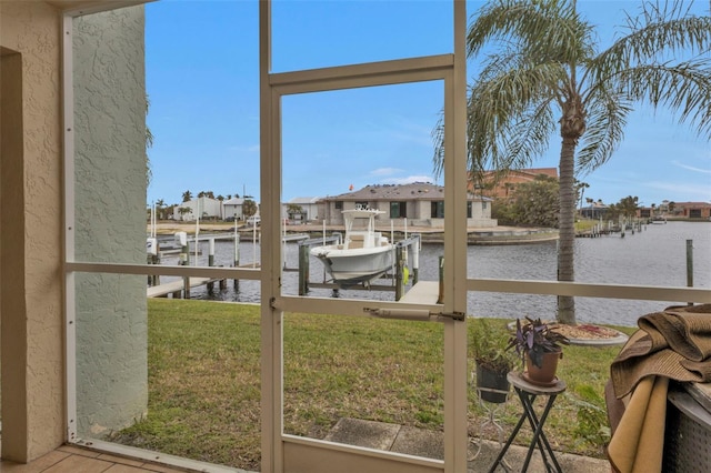 view of yard featuring a boat dock and a water view