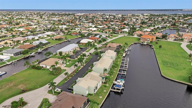 drone / aerial view featuring a residential view and a water view