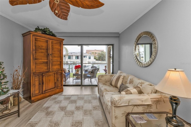 living room with light hardwood / wood-style flooring and ornamental molding