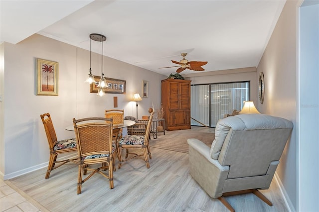 dining room with ceiling fan and light wood-type flooring