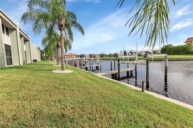 dock area featuring a lawn and a water view