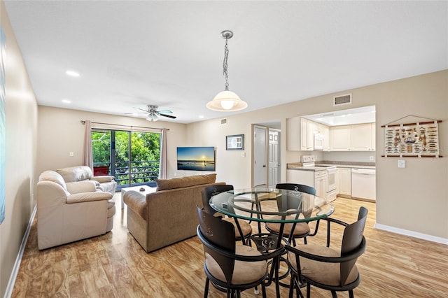 dining space featuring light wood-type flooring and ceiling fan