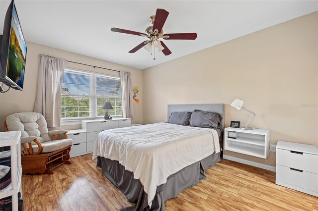 bedroom with light wood-type flooring and ceiling fan