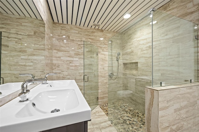 bathroom featuring vanity and a shower with door