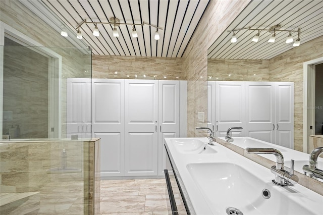 bathroom featuring a shower and vanity