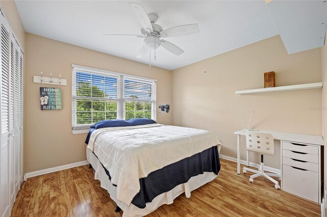 bedroom with ceiling fan, a closet, and hardwood / wood-style flooring