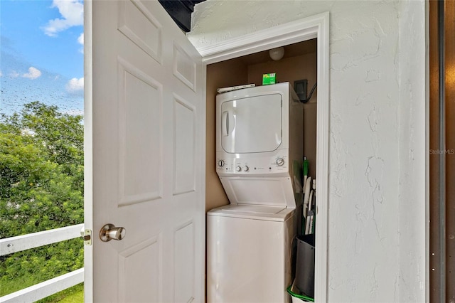 washroom with stacked washer and clothes dryer