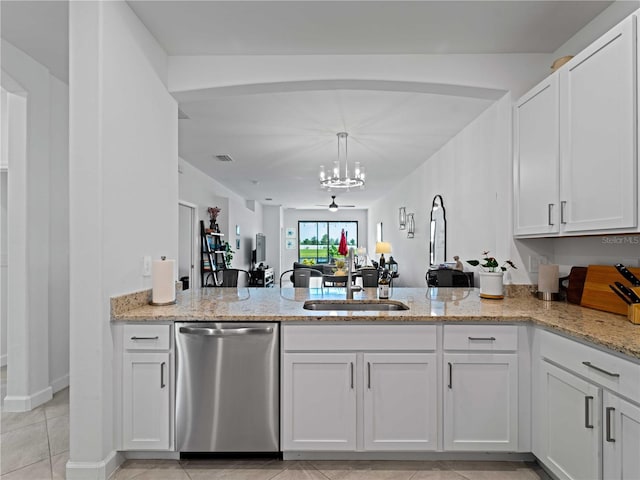 kitchen with dishwasher, light stone counters, a peninsula, white cabinetry, and a sink