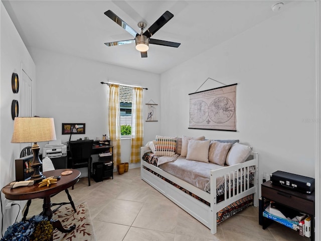 tiled bedroom featuring ceiling fan