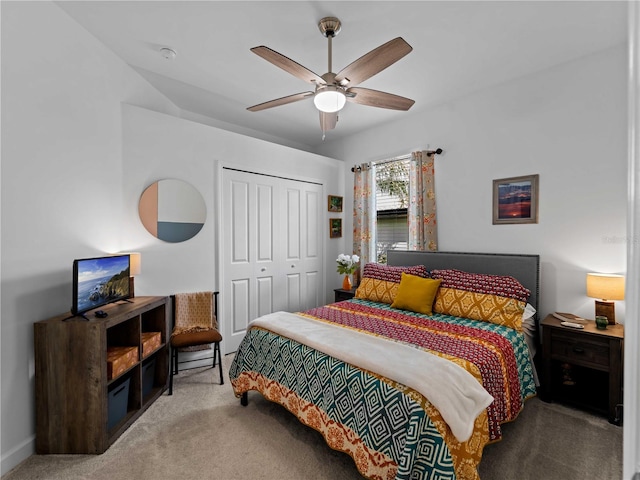 carpeted bedroom with ceiling fan and a closet