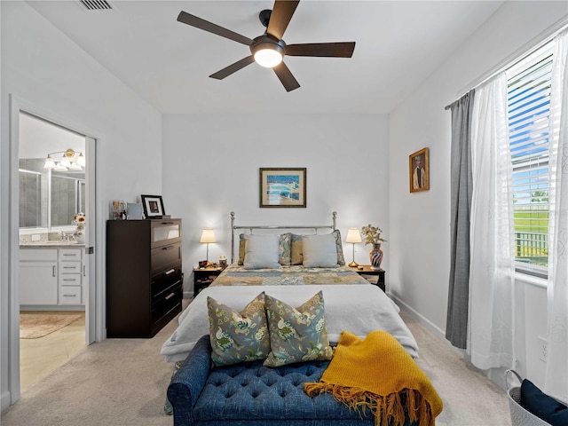 bedroom featuring ensuite bath, ceiling fan, and light colored carpet