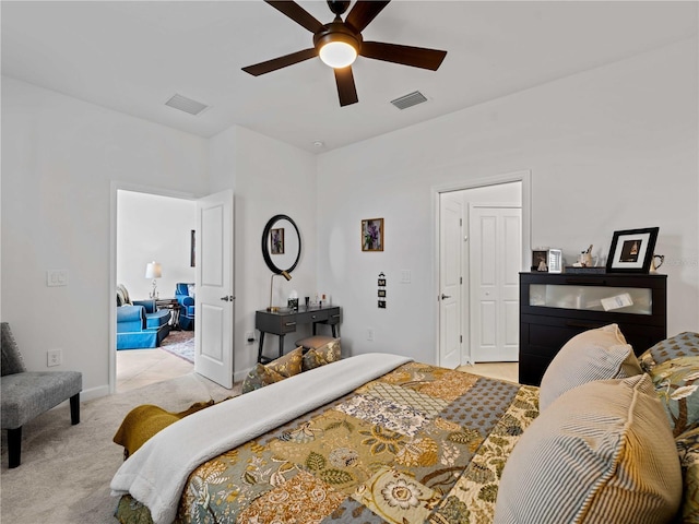 bedroom with light carpet, ceiling fan, visible vents, and baseboards