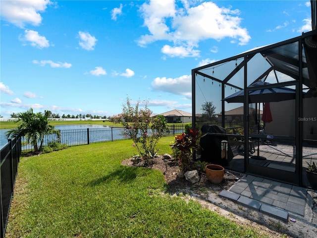 view of yard featuring a lanai, a fenced backyard, a water view, and a patio