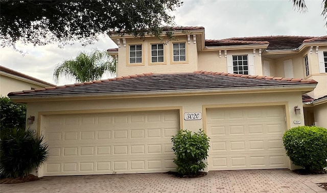 garage with decorative driveway